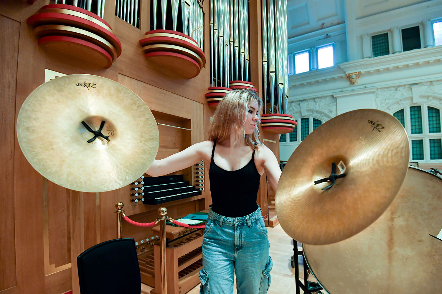 A percussionist holding large cymbals