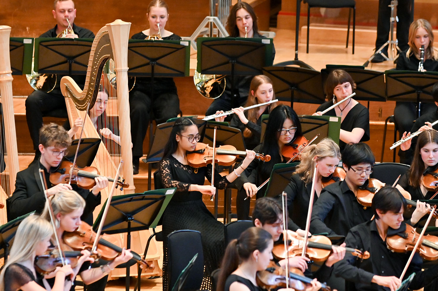 Students in the Junior Department Symphony Orchestra performing on stage in the Amaryllis Fleming Concert Hall